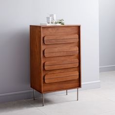 a tall wooden cabinet with five drawers