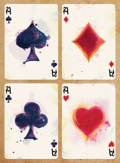 four playing cards with hearts and spades painted on the sides, all in different colors