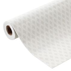 a roll of white patterned paper on a white background