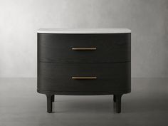 a black and white dresser with two drawers on it's sides, against a gray wall