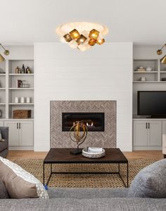 a living room with a fire place and couches in front of a tv mounted on the wall