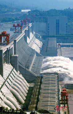 the water is rushing over the dam wall