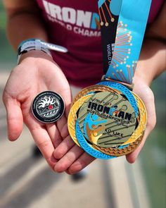 a person holding two medals in their hands