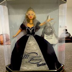 a barbie doll is in a glass case