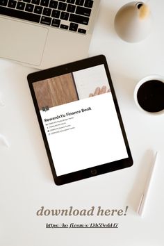 a tablet computer sitting on top of a white desk next to a cup of coffee