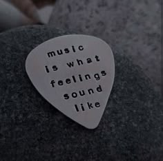 a guitar pick that says music is what feelings sound like