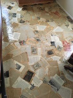 the floor is covered with old newspaper pages