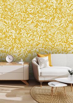 a living room with yellow wallpaper and white furniture