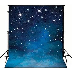 the stars are shining in the sky on a blue background with black stand and white backdrop