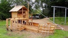 a wooden pirate ship made out of pallets and roped in to the ground