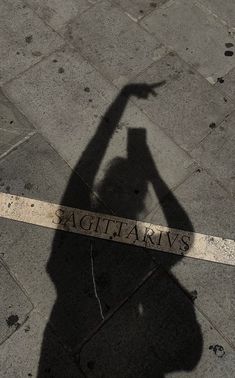 the shadow of a person holding a skateboard