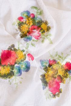 two pieces of cloth with flowers painted on them