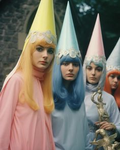 three women with colorful wigs standing in front of each other