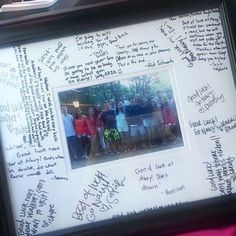 a group of people standing next to each other in front of a white board with writing on it