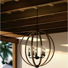 a chandelier hanging from a wooden ceiling