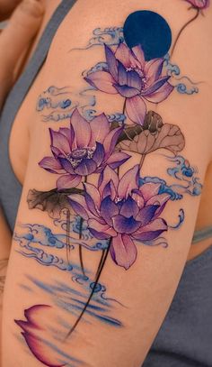 a woman's arm with purple flowers on it