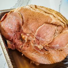 a large piece of meat sitting on top of a pan