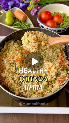 a pan filled with rice and vegetables on top of a table next to other dishes