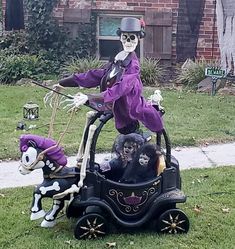 a skeleton riding on top of a toy car