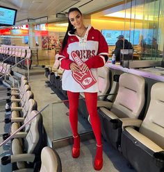 a woman in red and white is posing for the camera