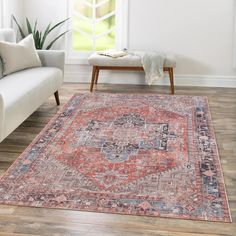 a living room area with a couch, chair and rug