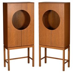 two wooden cabinets with circular doors on each side