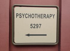 a sign that is on the side of a door saying, psychic therapy 5297