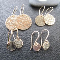 These gold disc earrings feature a hammered metal design, adding subtle texture and a shimmer to any look. The earrings come in three sizes, allowing you to pick the perfect size for you. Add a touch of glamour to your look with these gorgeous earrings.Four Sizes-Petite $32.00Small $39.00Medium $49.00Large $68.00 Ear Ring Ideas, Gold Disc Earrings, Hammered Earrings, Ear Ring, Coin Earrings, Gold Disc, Disc Earrings, Hammered Metal, Hammered Gold