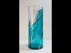 a blue glass vase sitting on top of a table