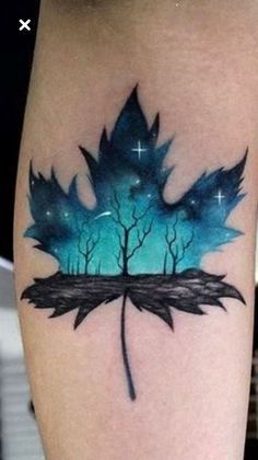 a tattoo with a blue leaf on it