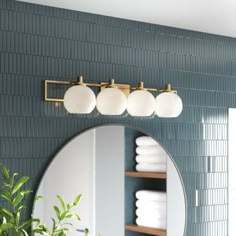 a bathroom with a round mirror and shelves