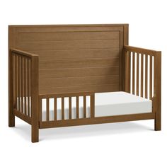 a small wooden crib with a mattress on the bottom and side rails, in front of a white background