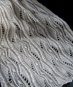 a white knitted shawl sitting on top of a table