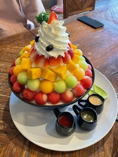 a platter filled with fruit on top of a wooden table