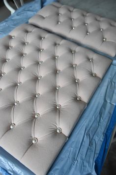 two mattresses with pearls on them sitting on a table