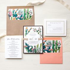 an assortment of wedding stationery with cactus and succulents on the front