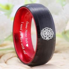 a black and red wedding ring with firefighter's emblem on it