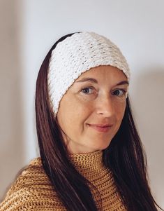 a woman wearing a white knitted headband