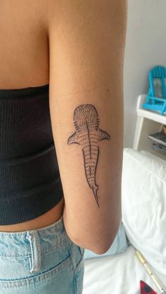 a woman with a shark tattoo on her arm