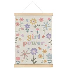 a white wall hanging with flowers and the words girl power on it's side