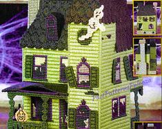 a green and purple house with lots of windows