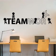 there is a wall sticker that says teamwork on the side of a desk