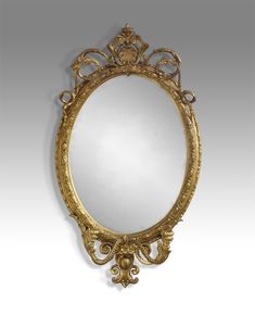 an ornate gold framed mirror against a white background