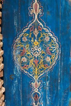 an old wooden door painted blue and yellow