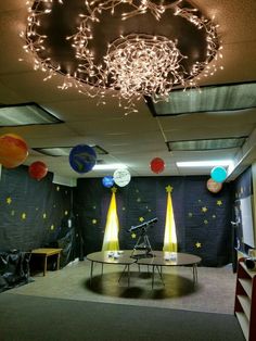 a room with lights and decorations on the ceiling