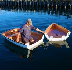 a man sitting in a small boat on the water