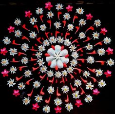 an overhead view of a flower arrangement made out of paper machs and colored thread