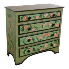 a green painted dresser with pink flowers on it