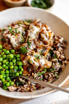 a white bowl filled with rice and peas