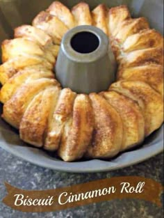 a bundt cake sitting on top of a pan with cinnamon rolls in it's center